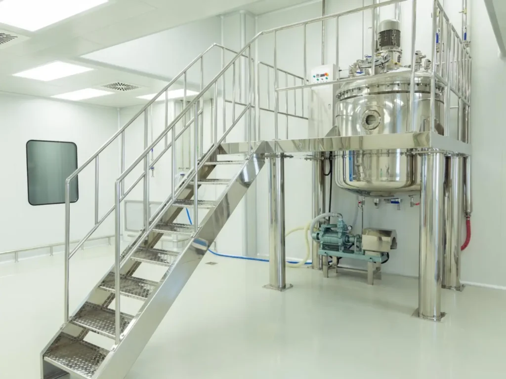 Industrial stainless steel processing tank and stairs.