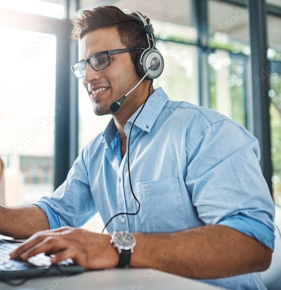 Smiling man wearing headset working
