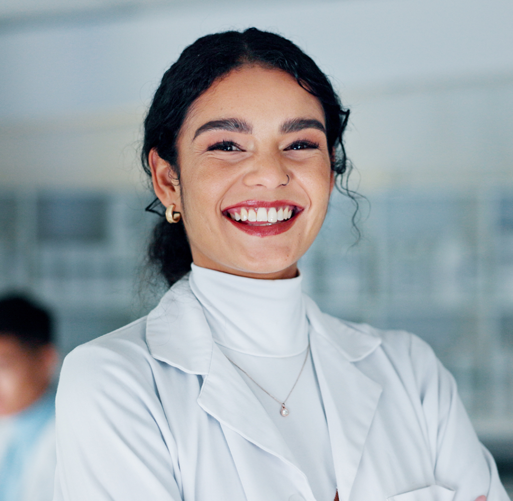 Smiling female scientist in lab.